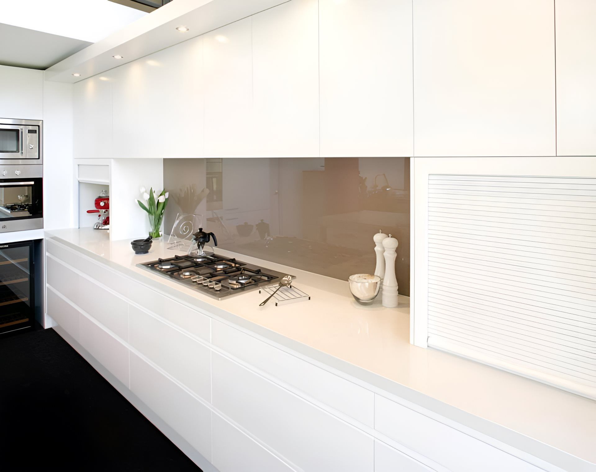 A white kitchen bench with cupboards and drawers — The Right Kitchen Company In Berkley, NSW