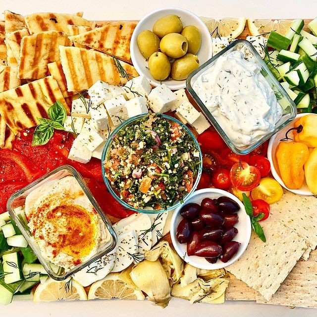 There are many different types of food on the cutting board.