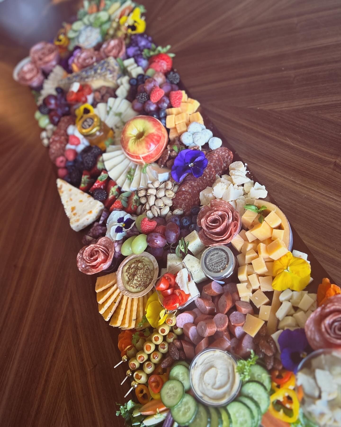 A wooden tray filled with fruits and bread