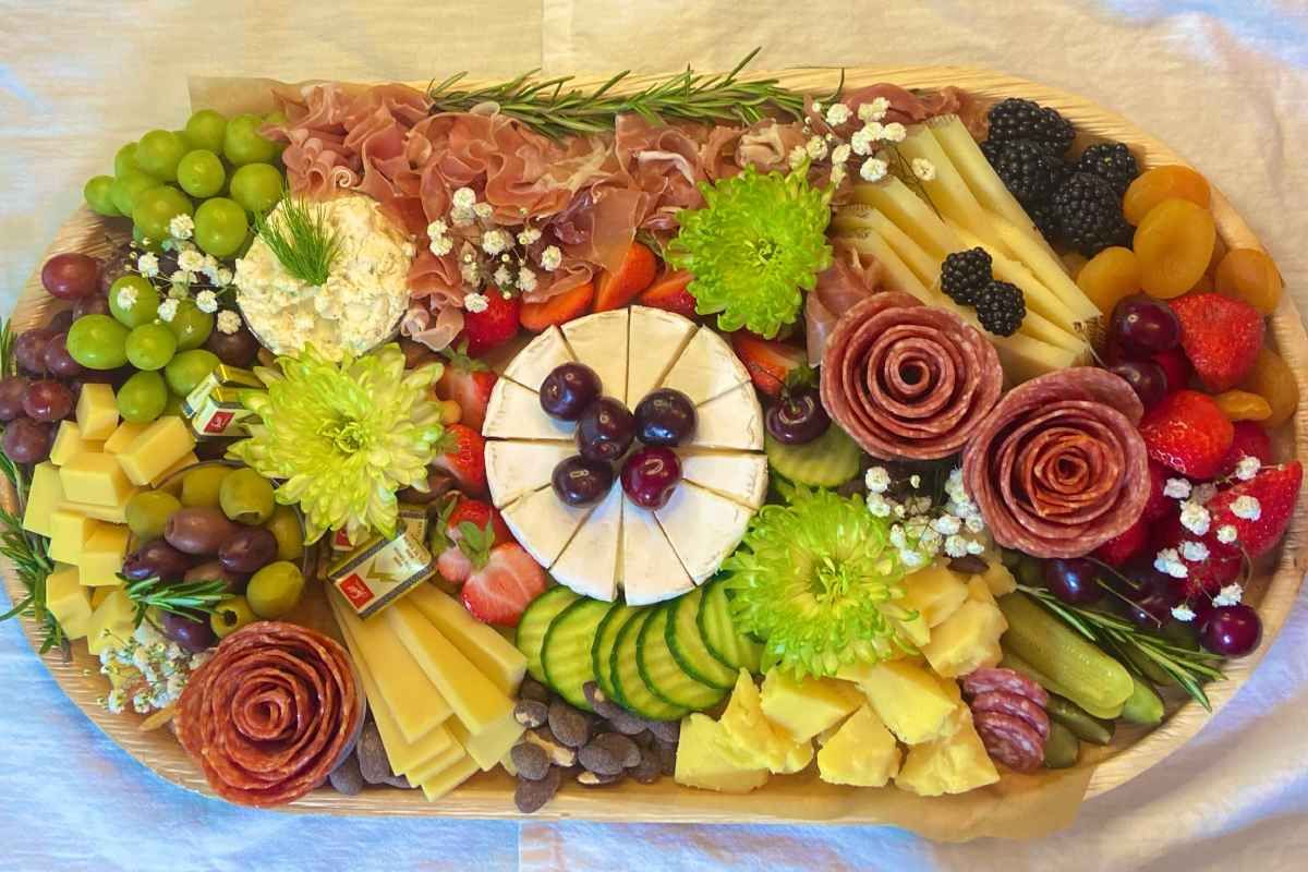 A wooden tray filled with lots of different types of food.