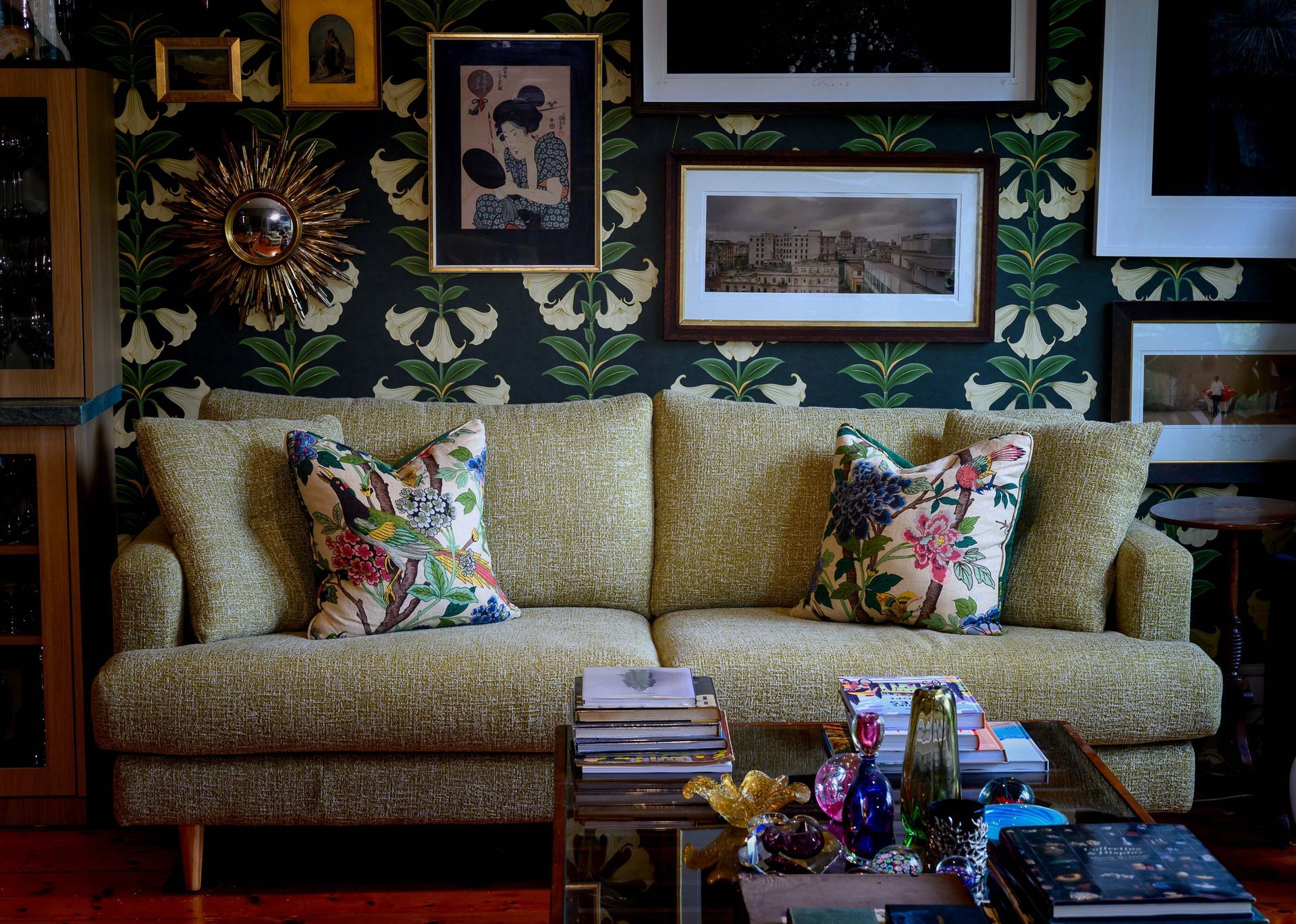 A living room with a couch and lots of pictures on the wall