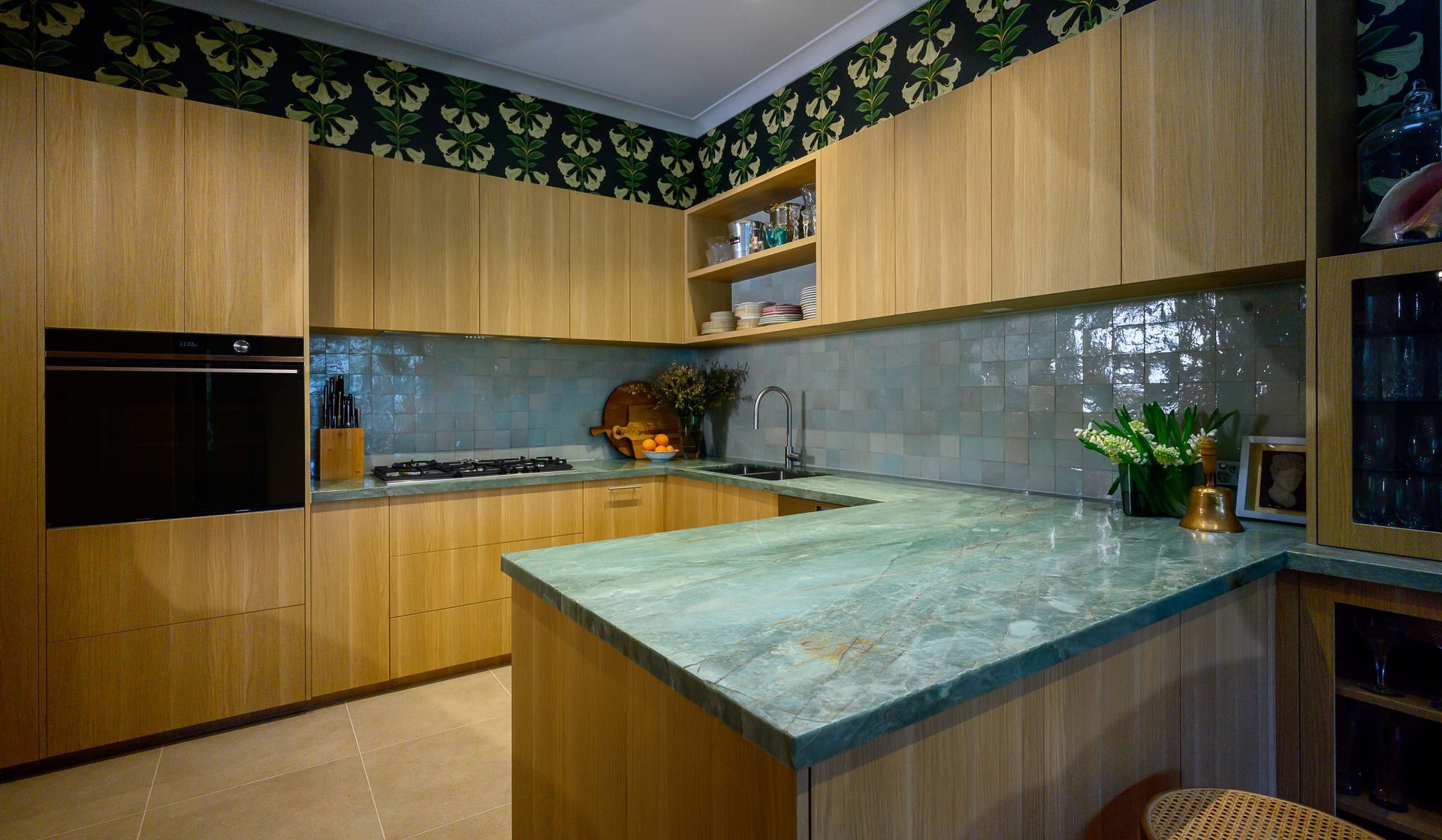 A kitchen with wooden cabinets and a green counter top.