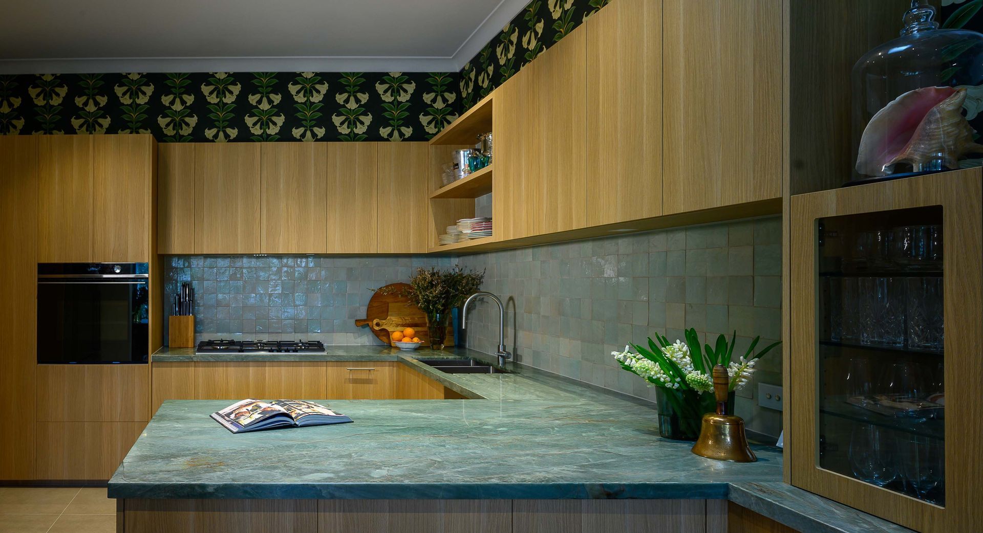 A kitchen with wooden cabinets and a green counter top.