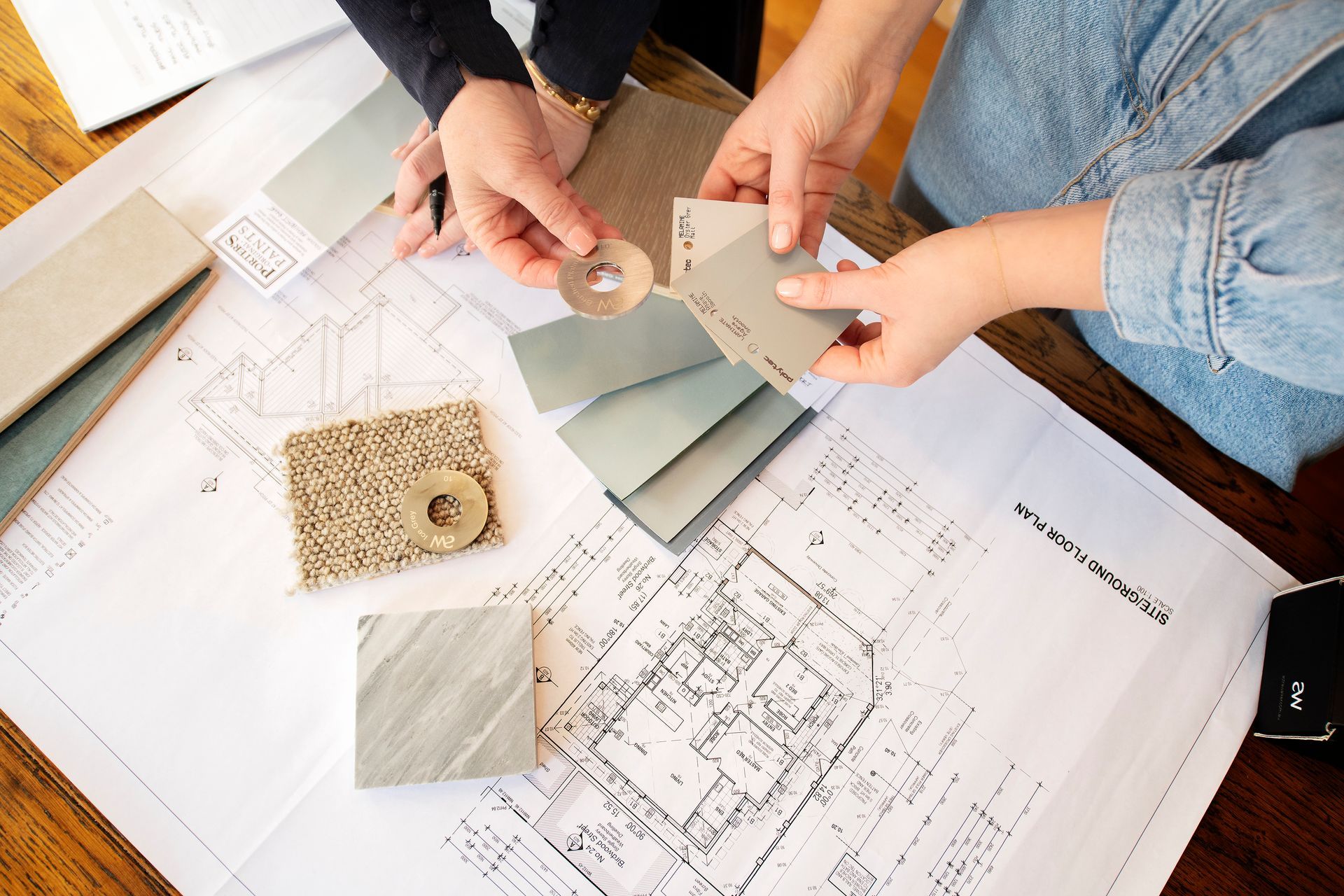 A patio with a couch, chairs, table and a ceiling fan.