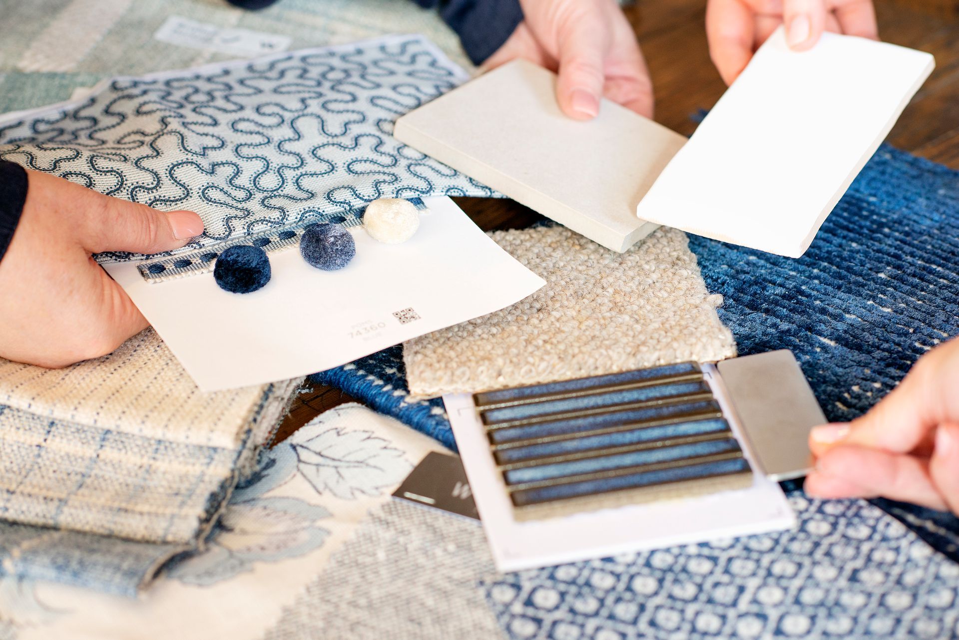 A person is holding a pen over a piece of paper.