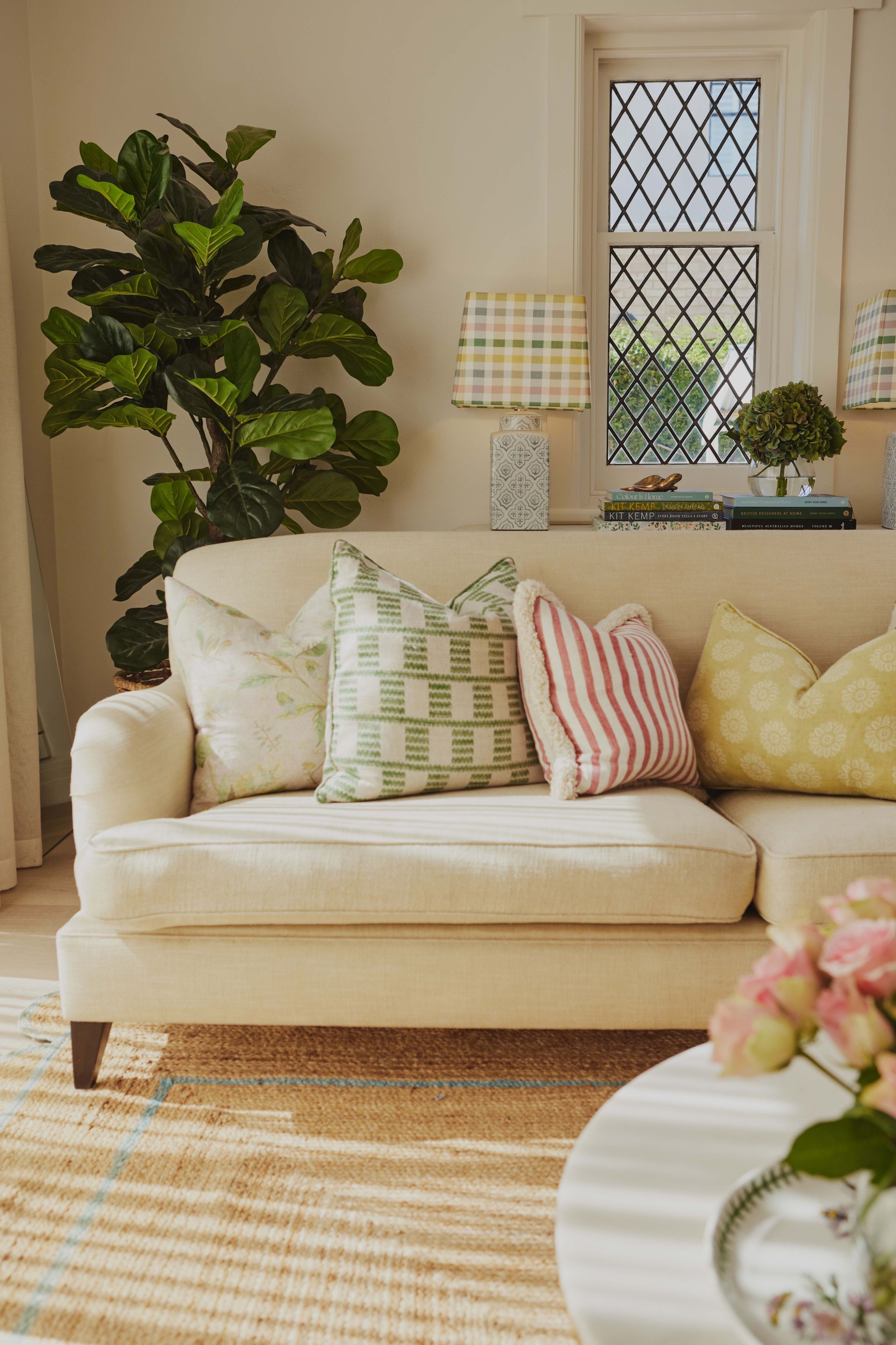 A living room with a couch, table, and plant.