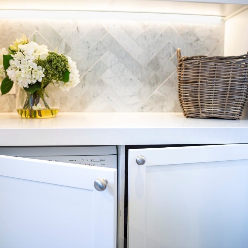 A bathroom with a toilet, sink, mirror and walk in shower.