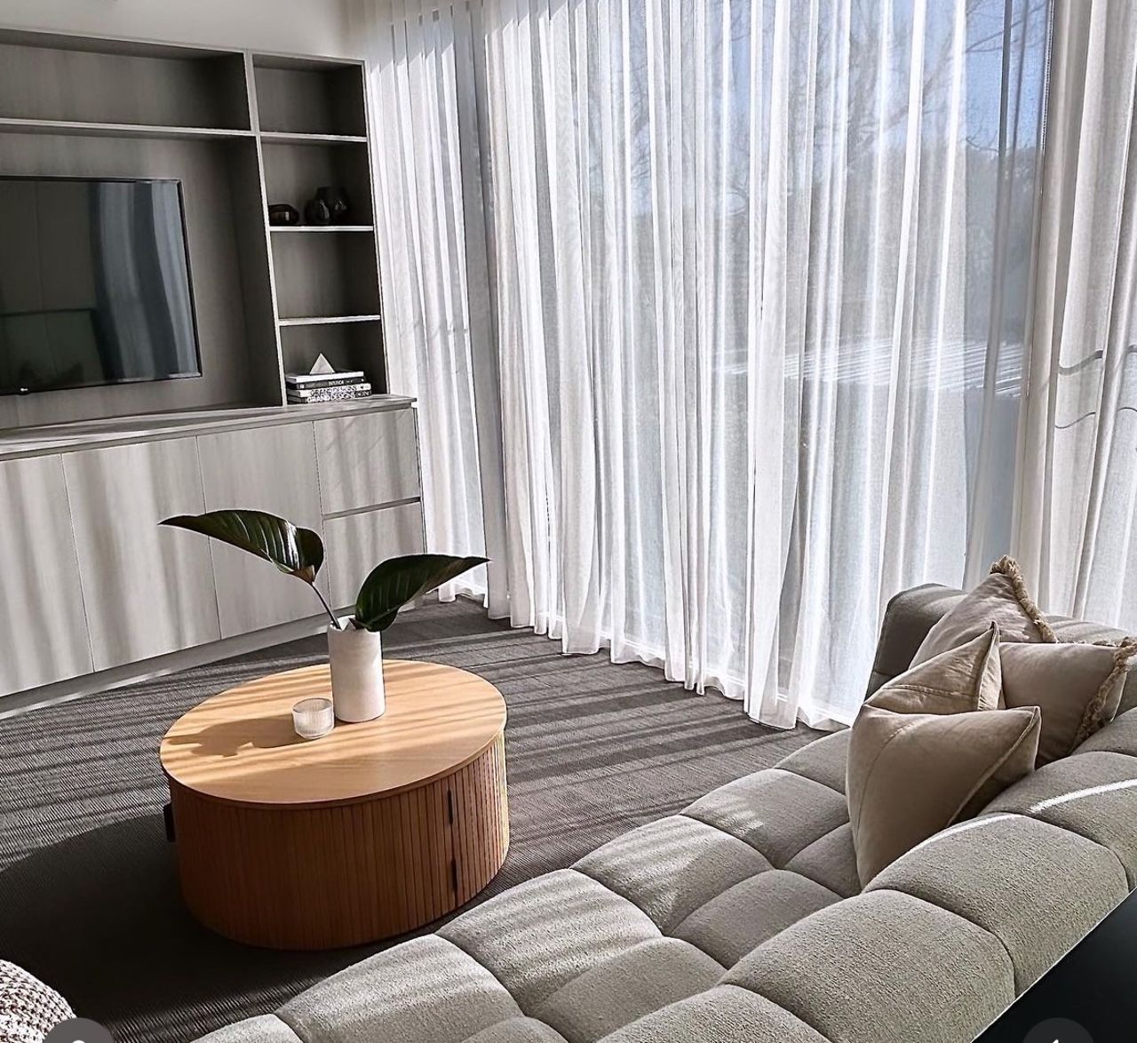 A living room with a sliding glass door and curtains.