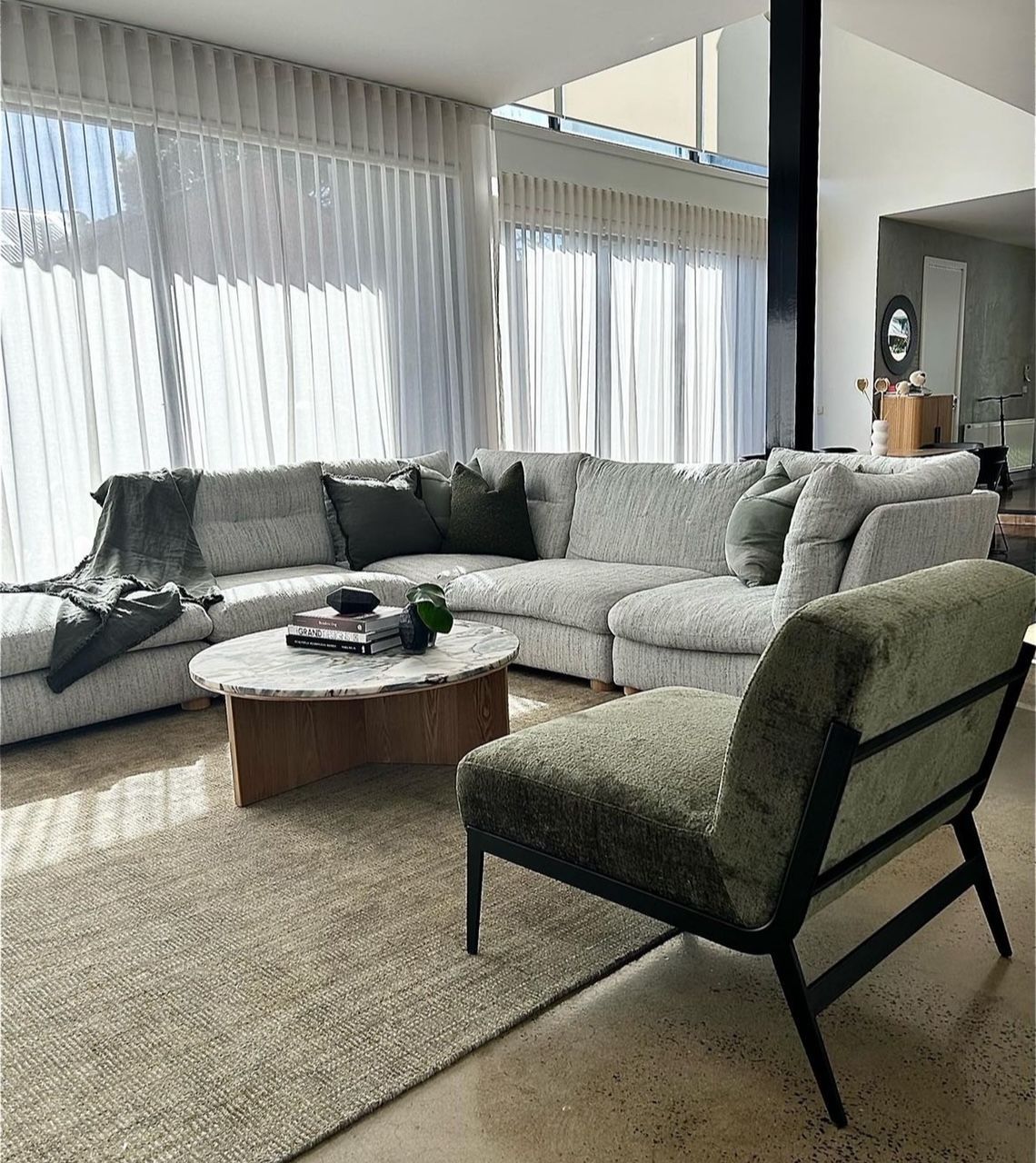 A dining room with a table and chairs and shutters on the windows.