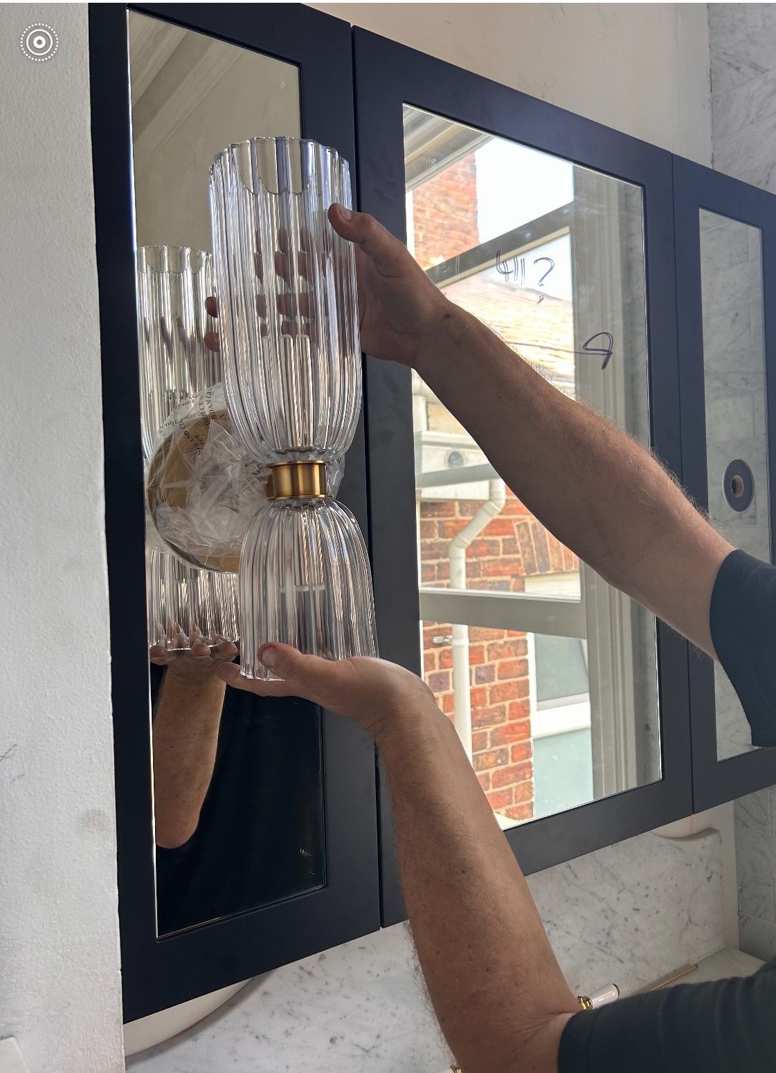 A person is measuring a piece of wood with a ruler.