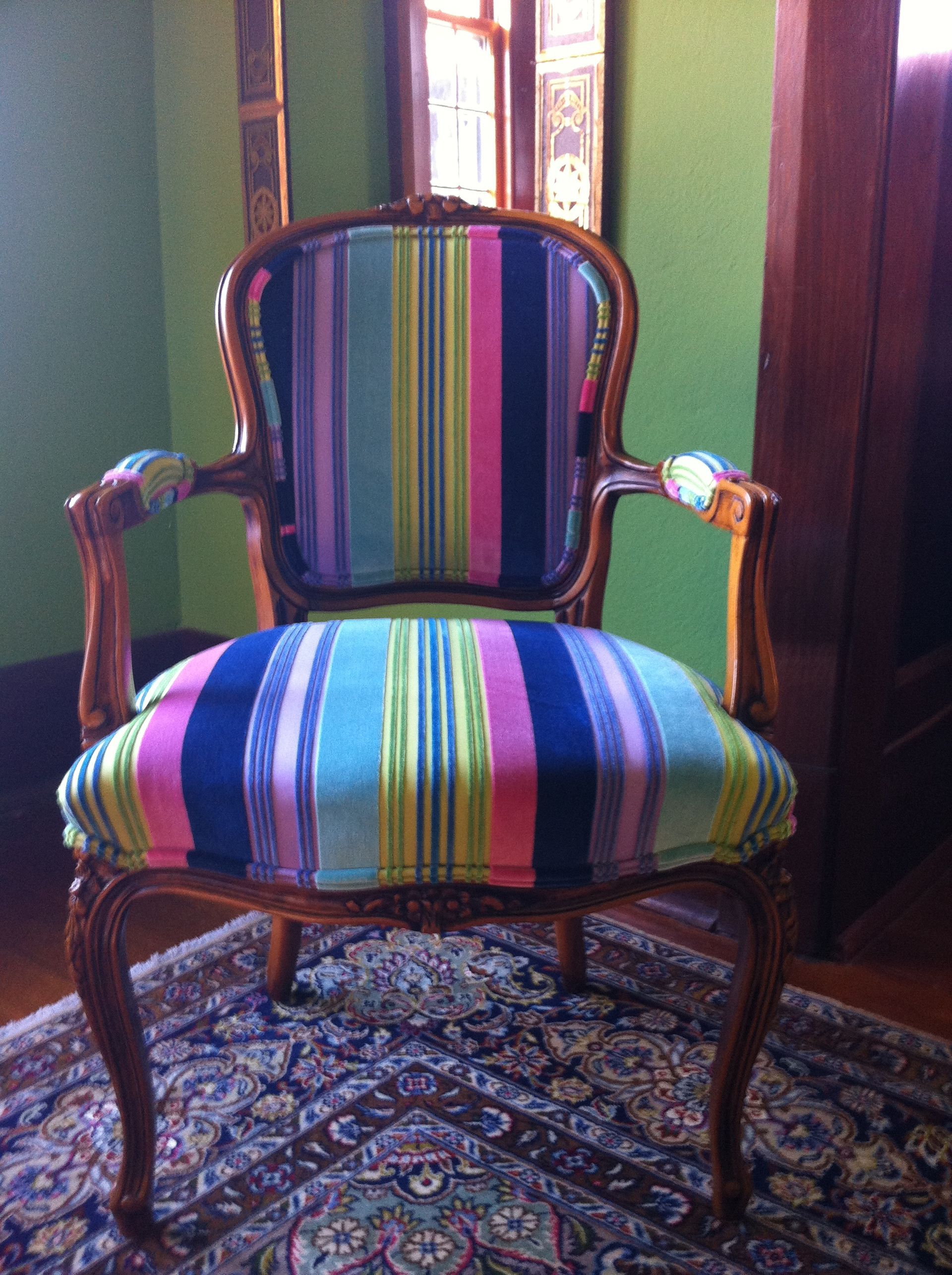 A person is using a stapler on a piece of wood.