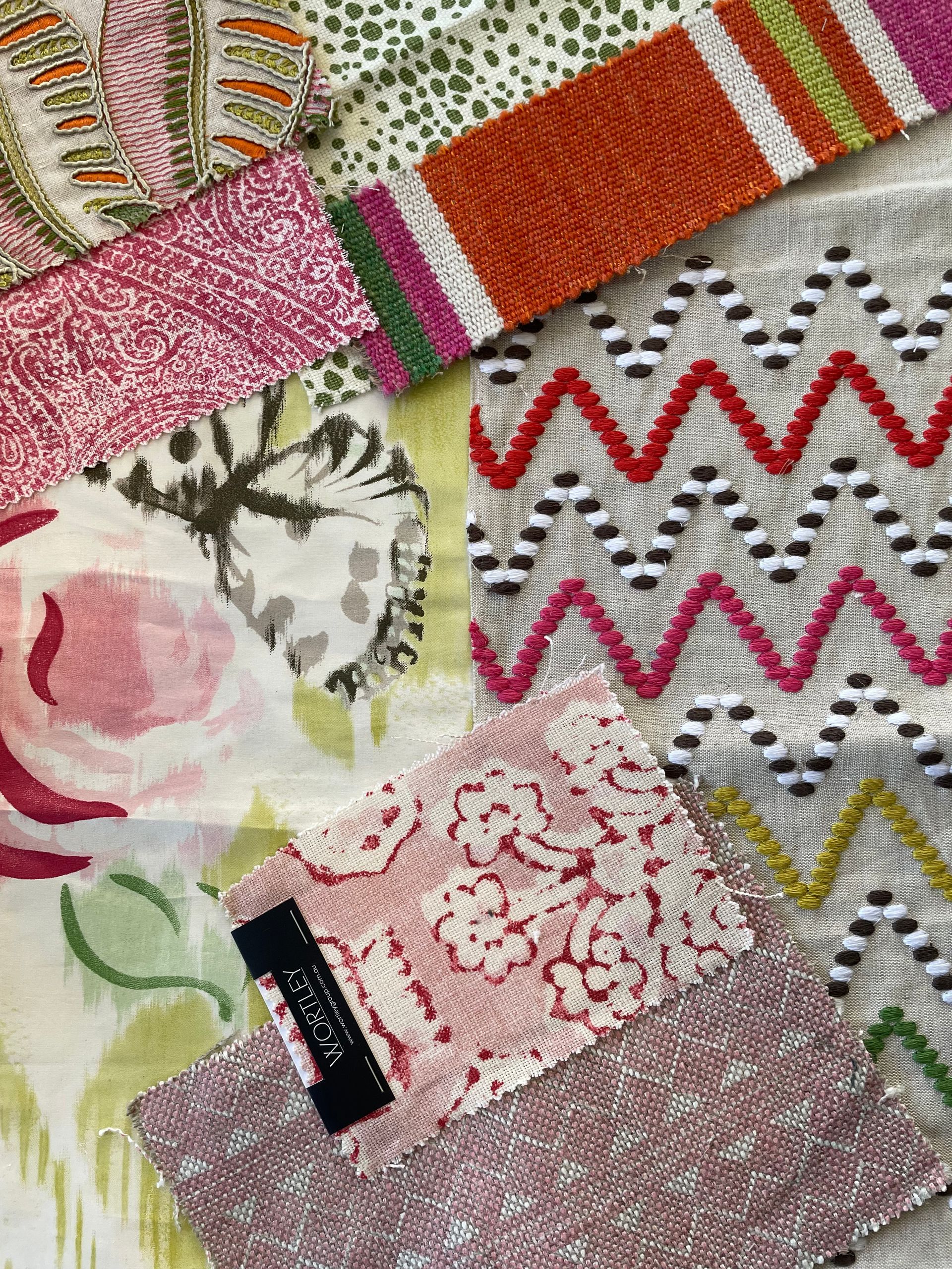 A table with pillows and a vase of flowers on it