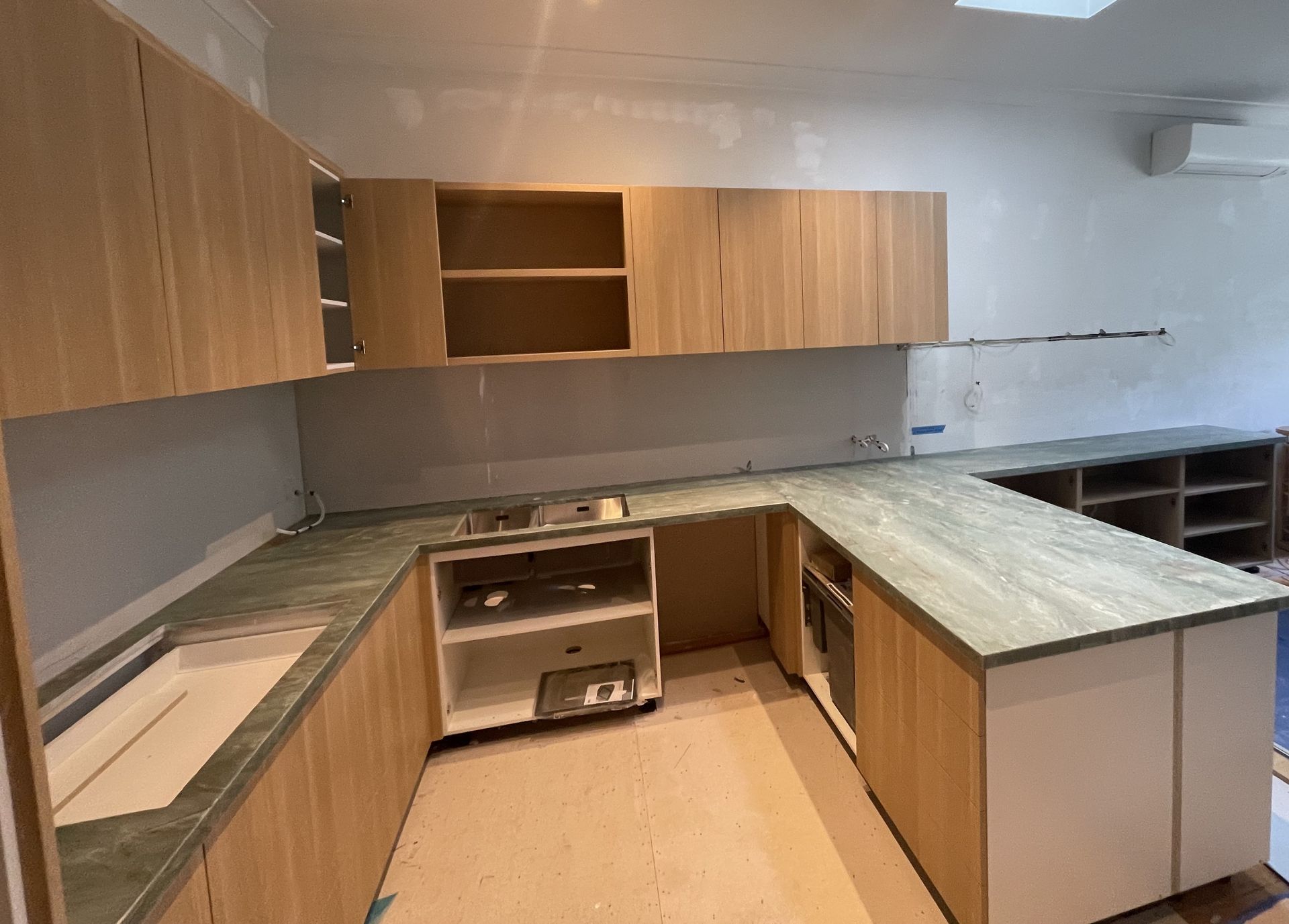 A man is using a circular saw to cut a piece of wood.