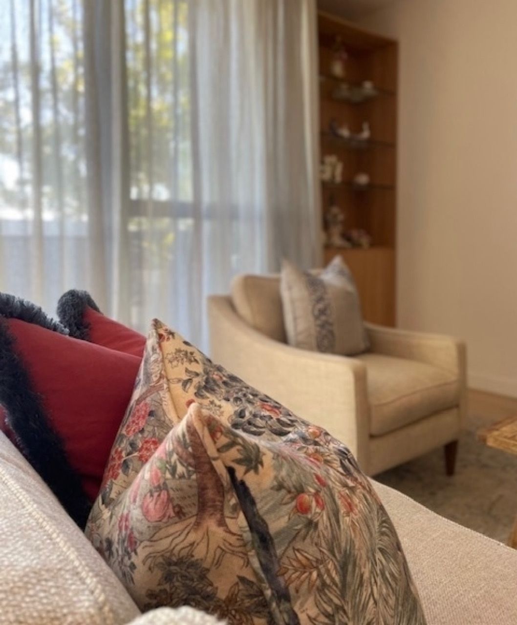 A bedroom with a bed, nightstand, lamp and dresser.