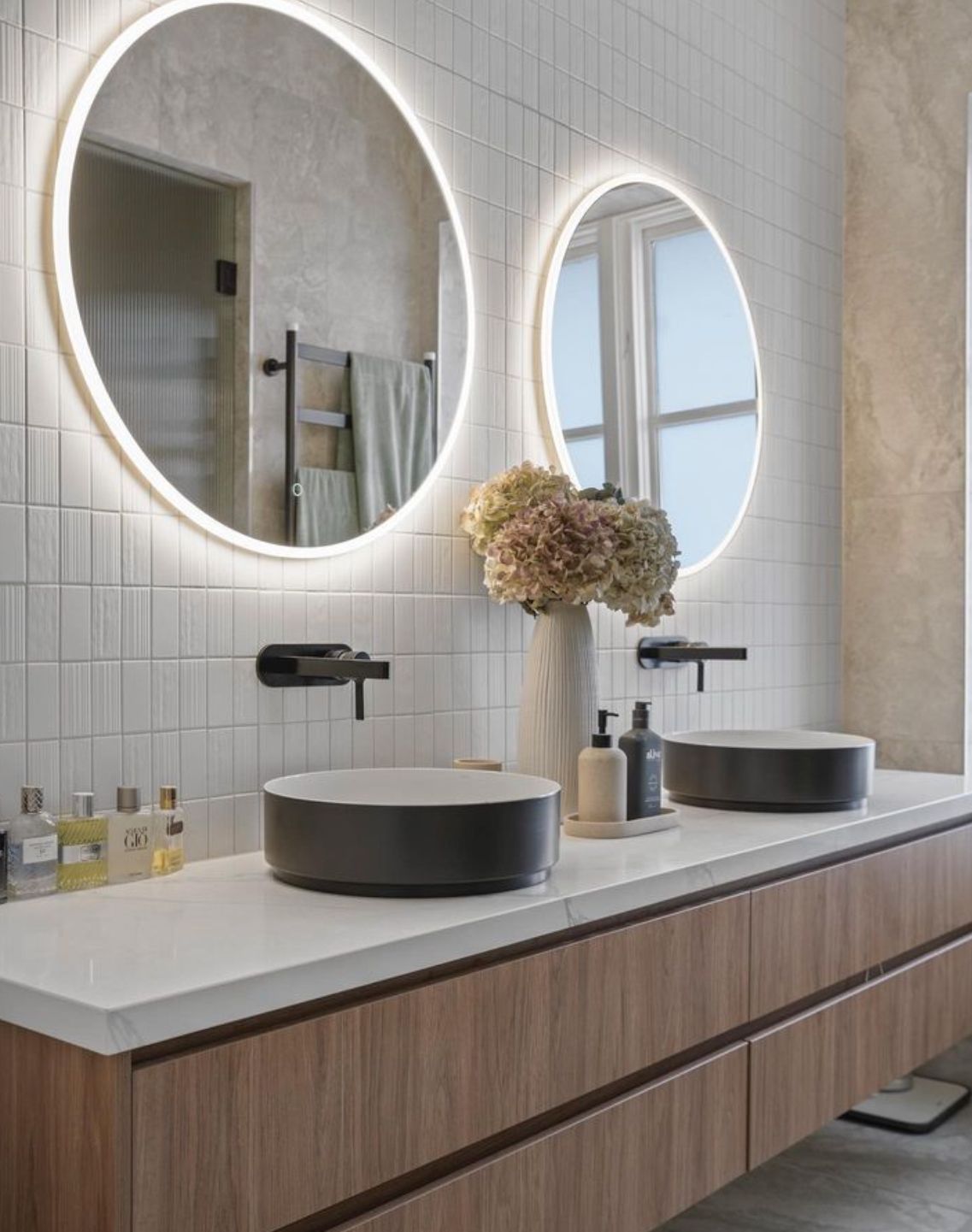 A bathroom with two sinks and two mirrors.