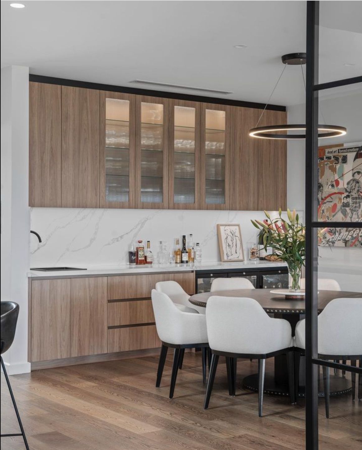 A kitchen with a table and chairs in it