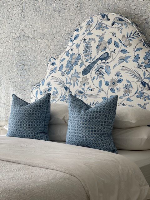 A living room with a couch, chair, coffee table and bookshelves.