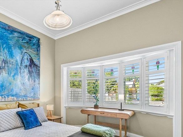 A living room with a couch and a lamp