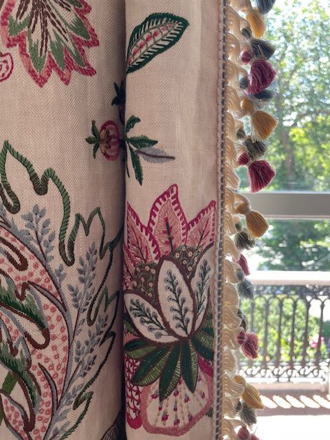 A close up of a curtain with flowers on it