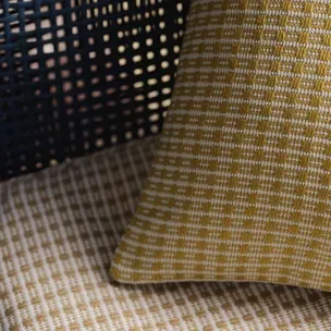 A close up of three pillows sitting on top of a bed.