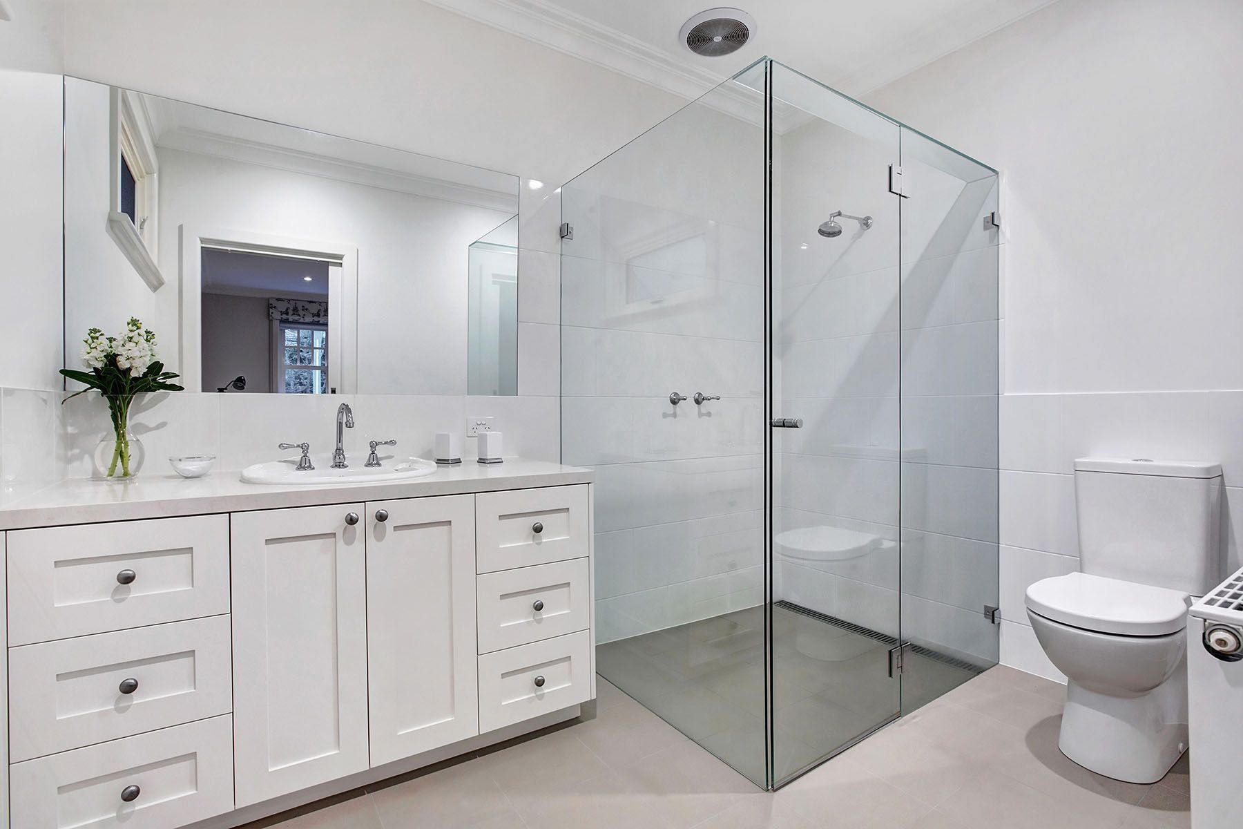A bathroom with a bathtub, sink, shower and mirror.