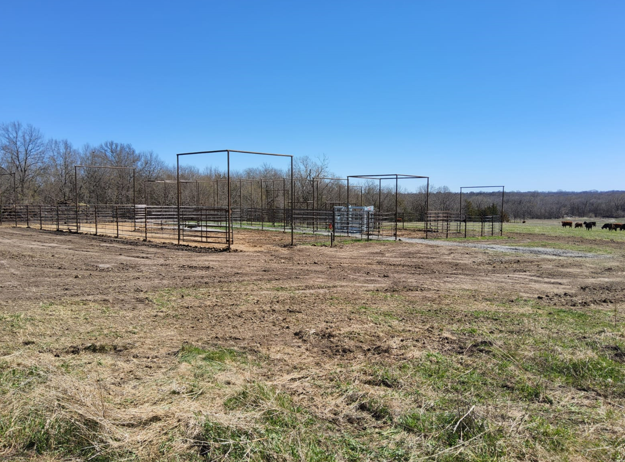 A fenced in field with a blue sky in the background