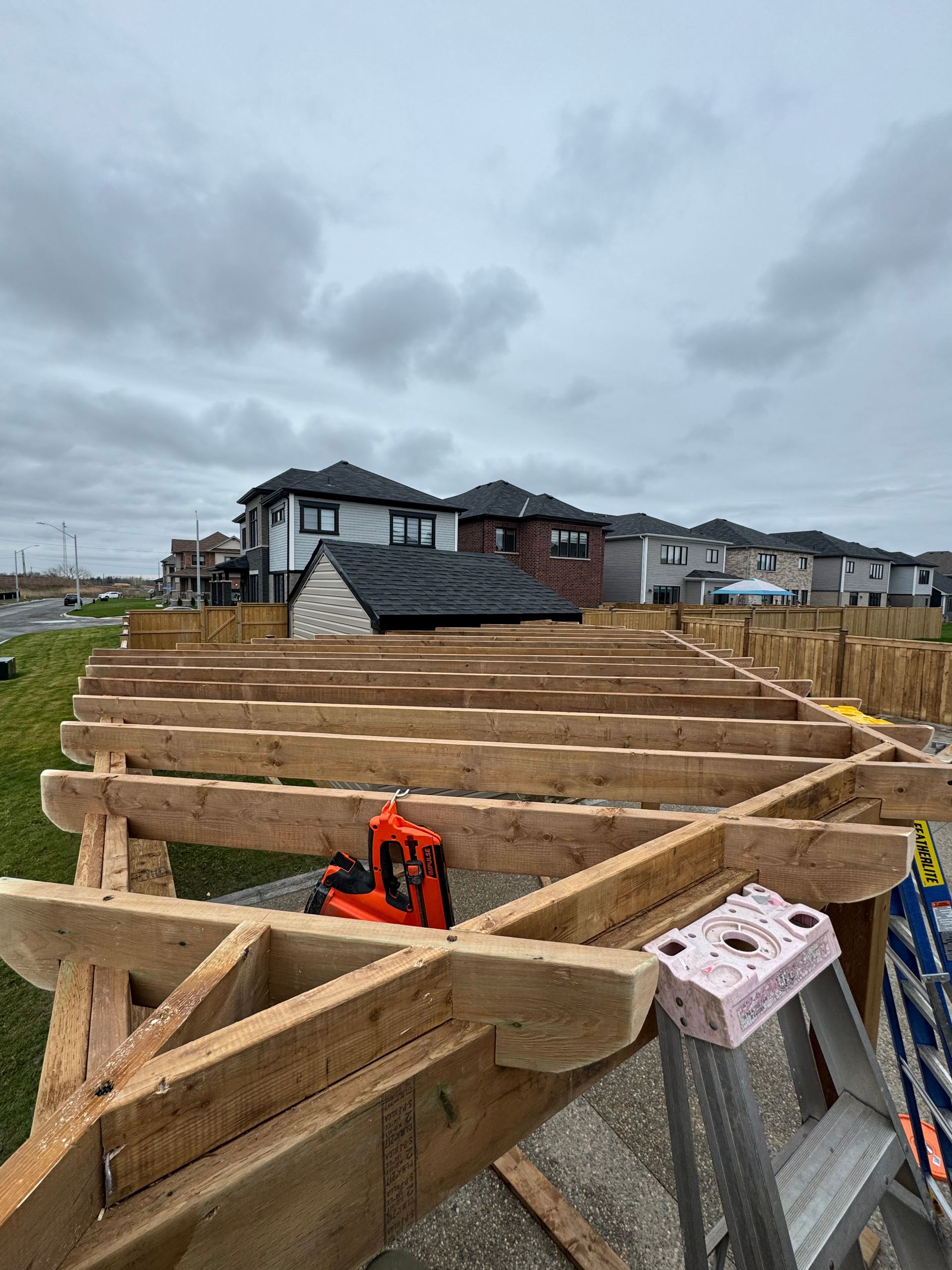 A wooden structure is being built in a residential area.