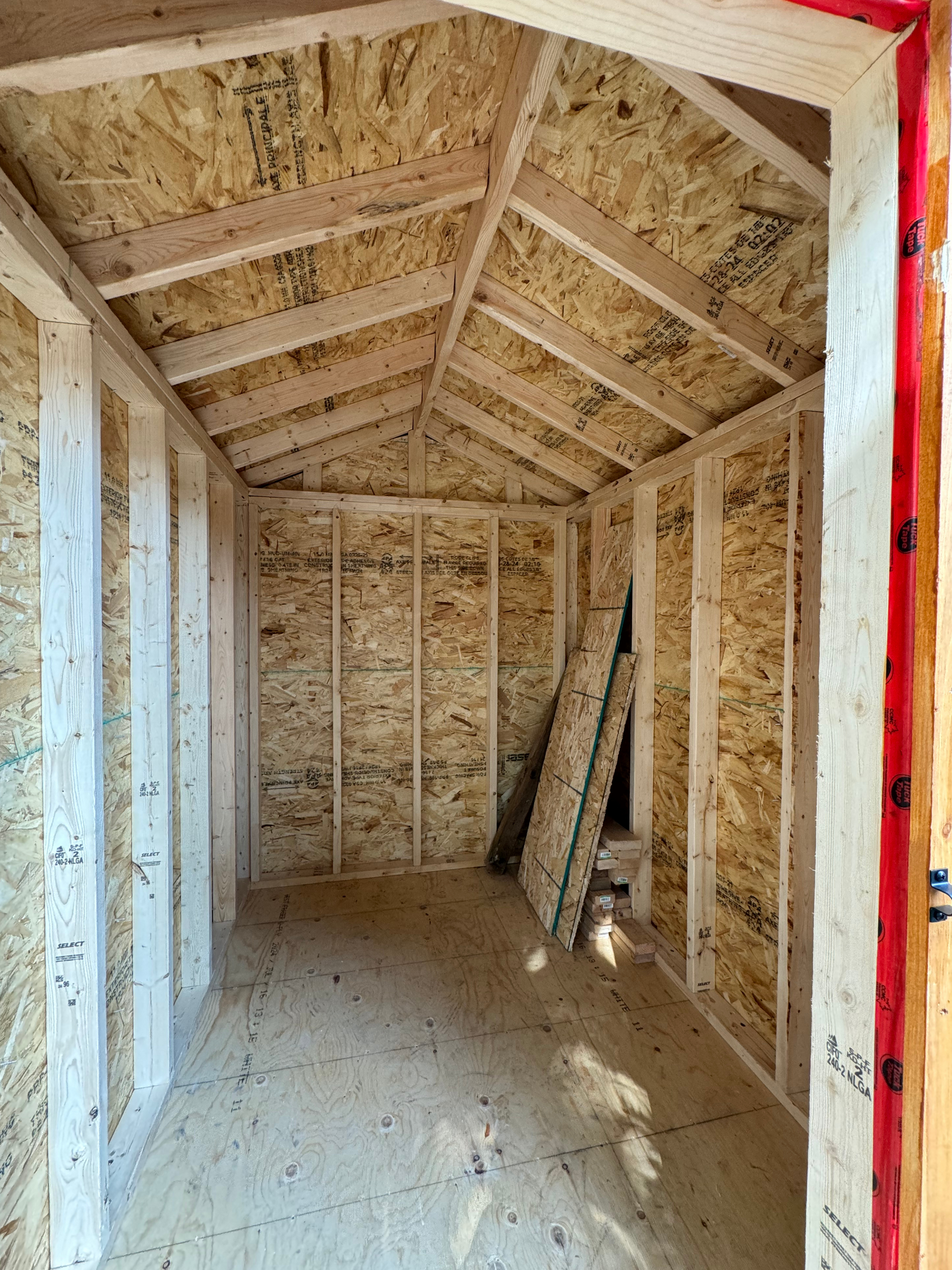 The inside of a wooden shed under construction.