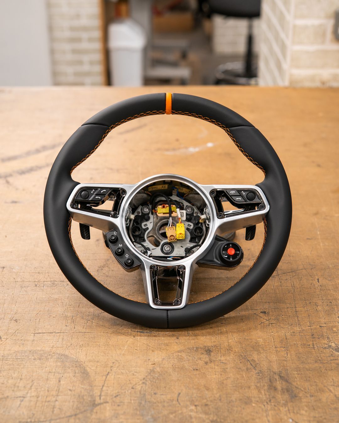 porsche 918 spyder steering wheel retrim black nappa leather orange racing band d:class dclass auto automotive near me interior stitch stitching oem 