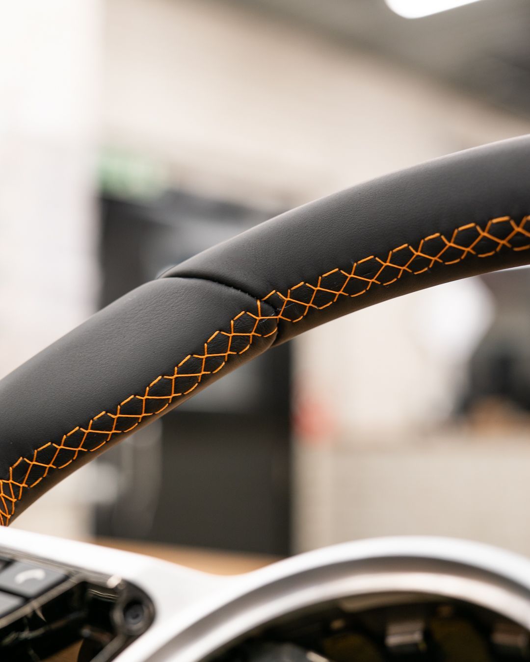 porsche 918 spyder steering wheel retrim black nappa leather orange racing band d:class dclass auto automotive near me interior stitch stitching oem 