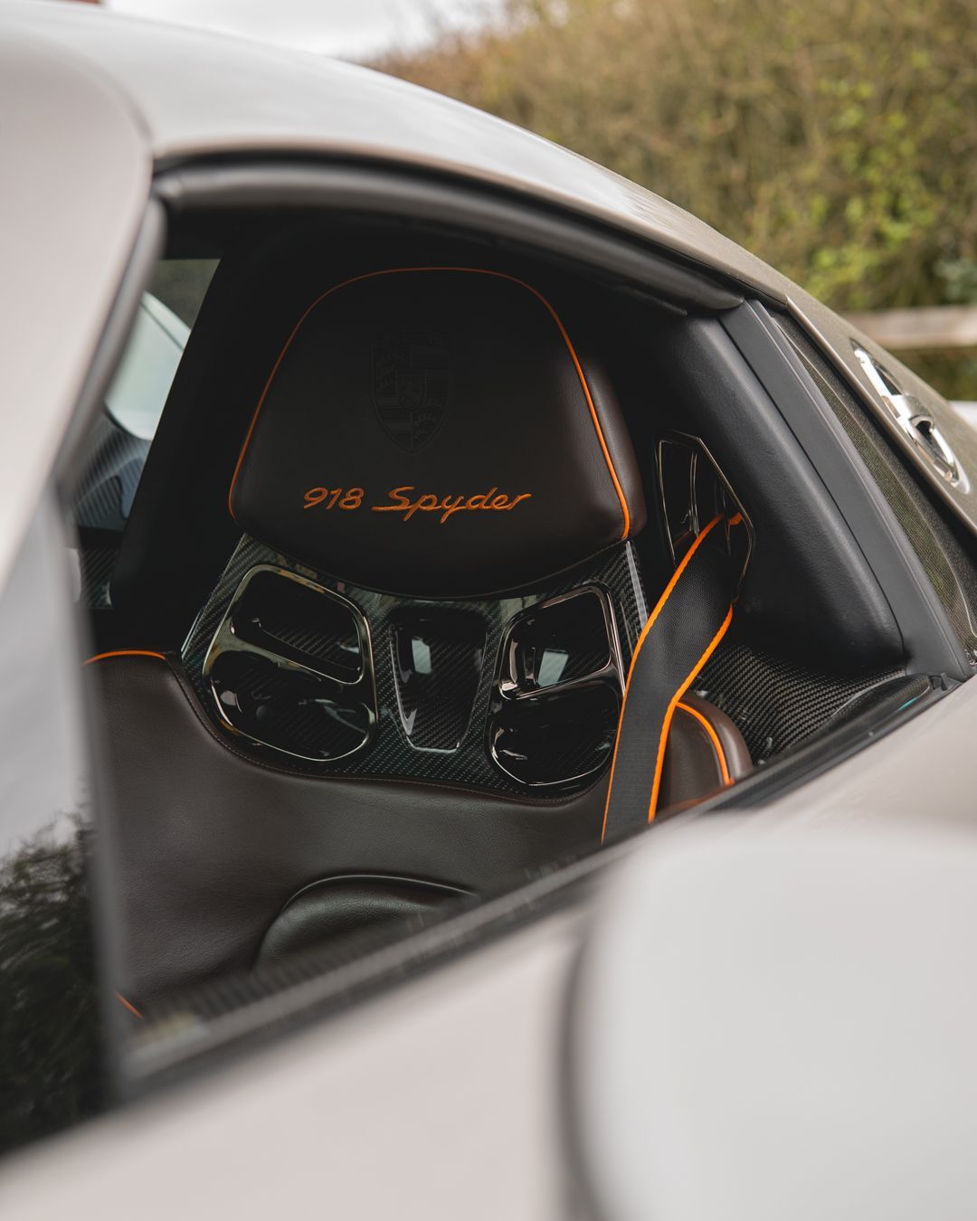 porsche 918 spyder steering wheel retrim black nappa leather orange racing band d:class dclass auto automotive near me interior stitch stitching oem 