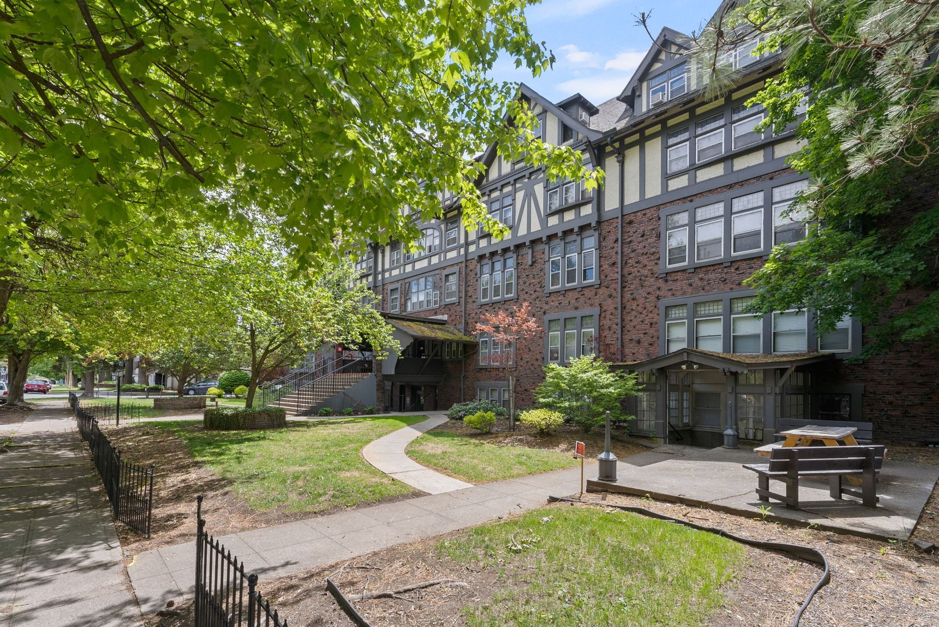A large brick building with a picnic table in front of it.
