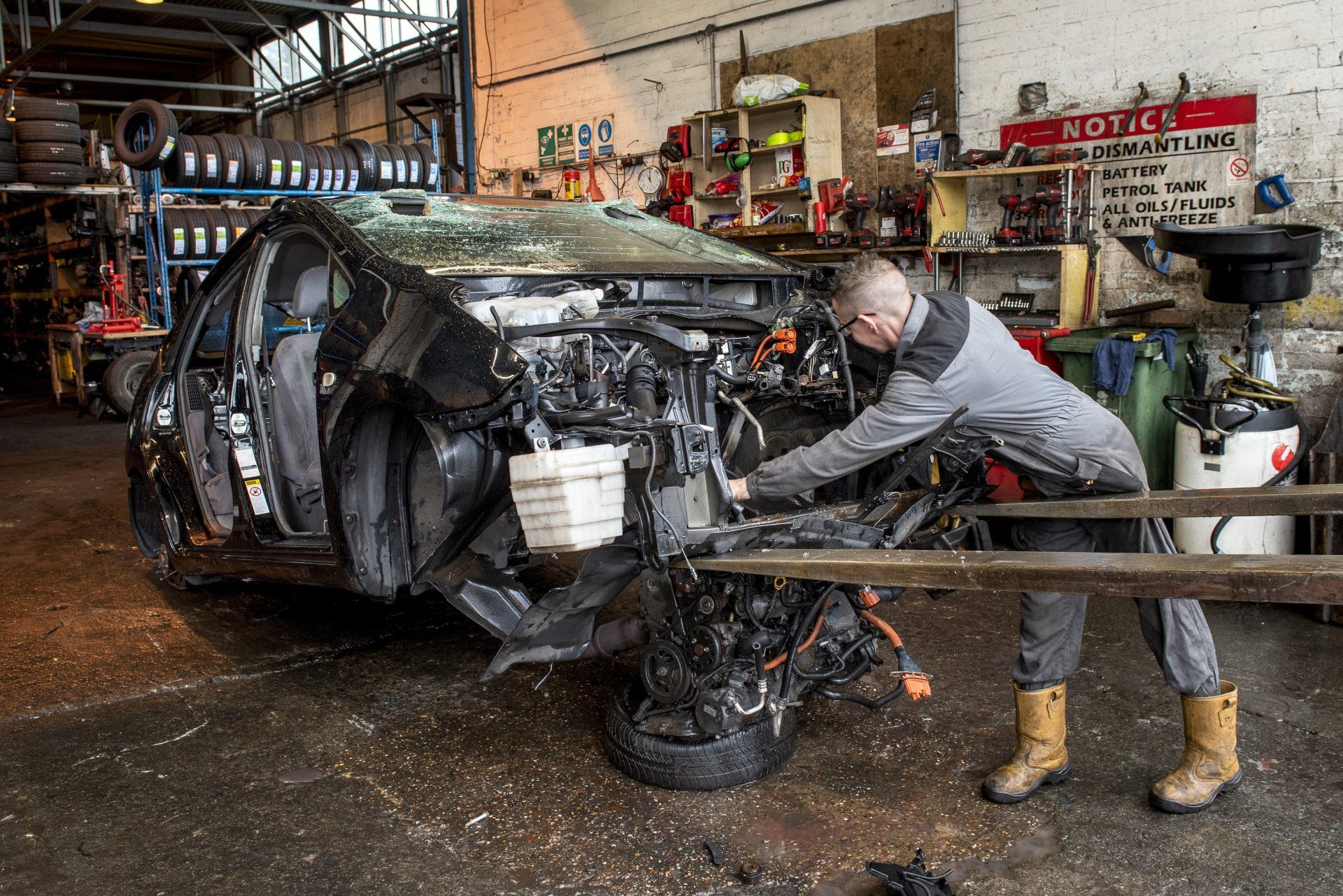 Man dismantling car parts