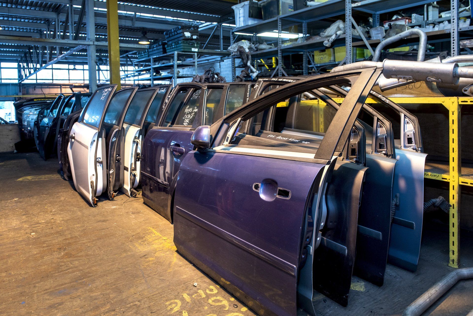 Scrapped car doors piled up in a row