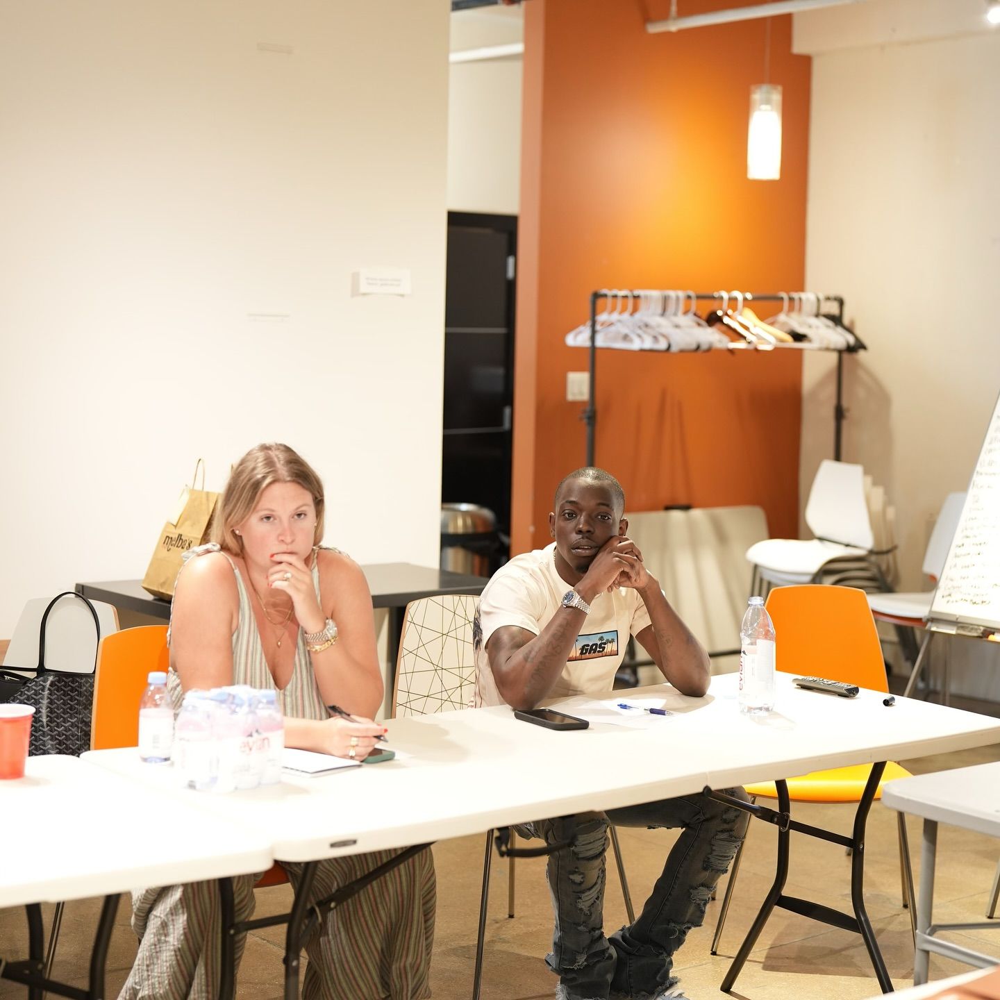 Ackquille and Adren sit at a table in a room