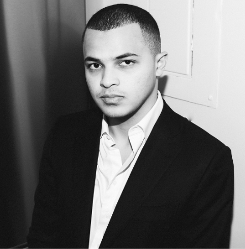 A black and white photo of a man in a suit