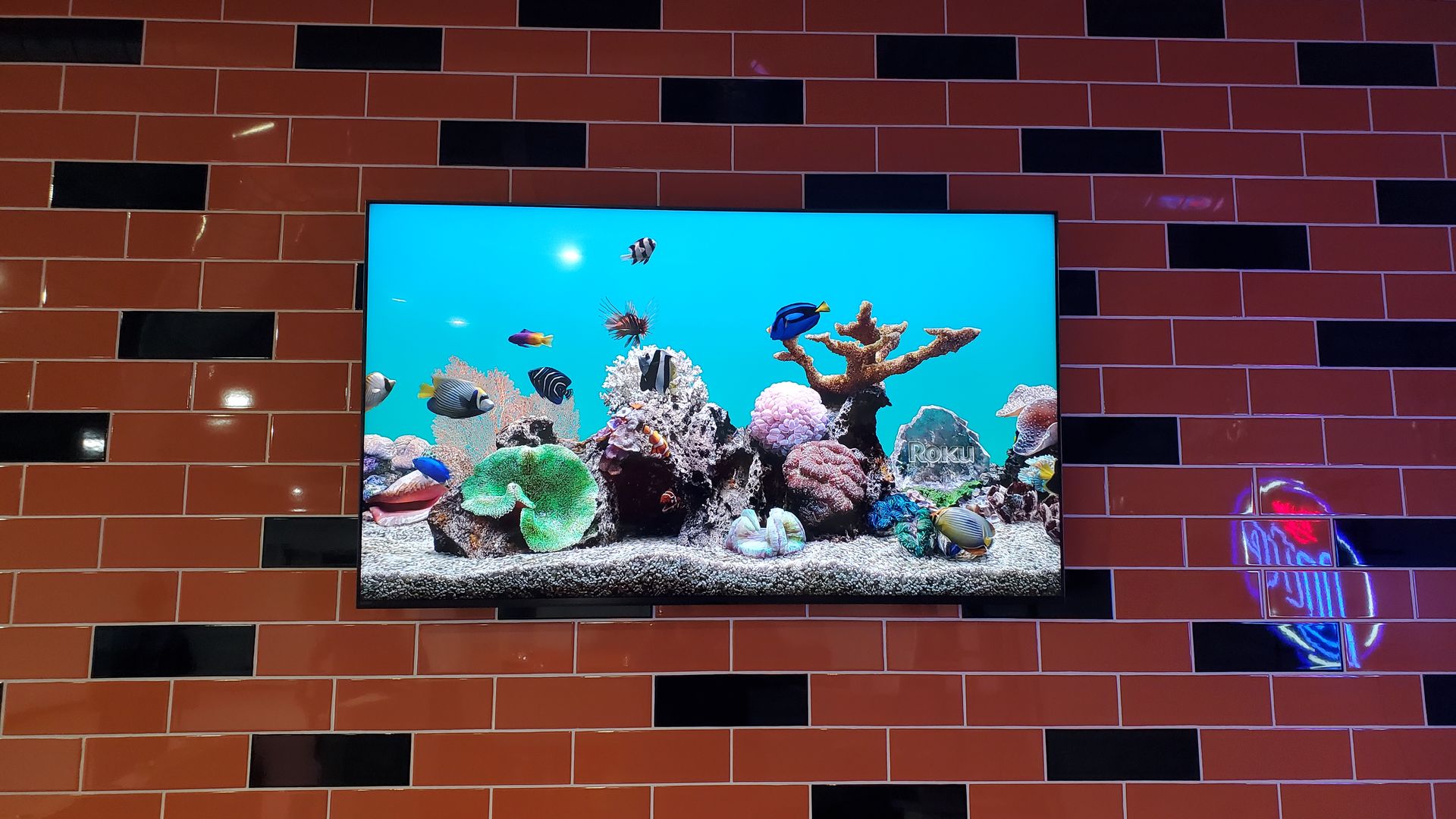 TV screen mounted on a ceramic tile wall custom mounted.