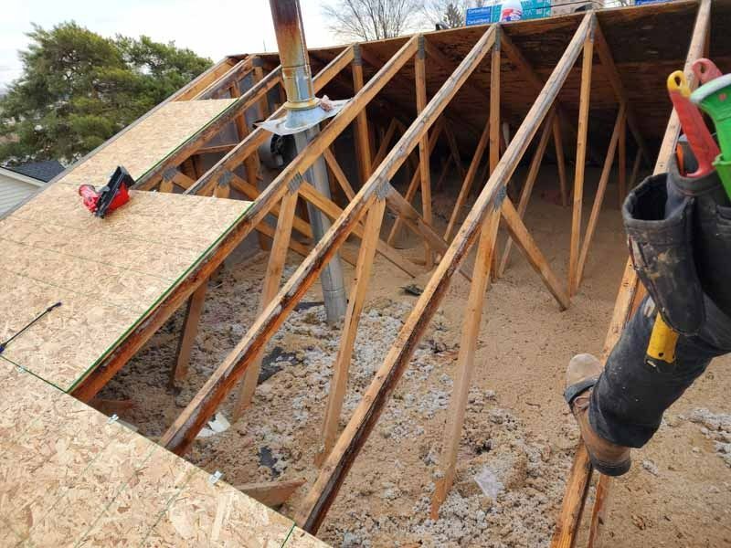 A person is working on the roof of a house.