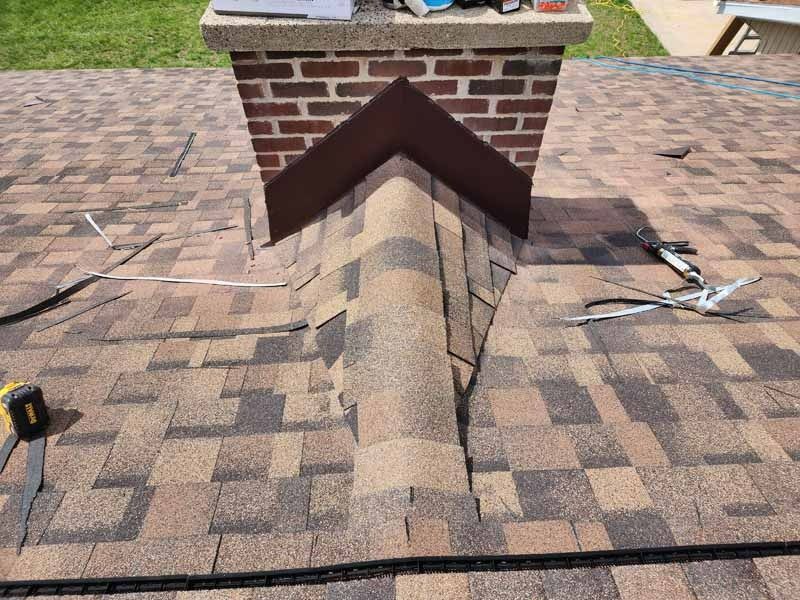 A roof with a brick chimney on top of it