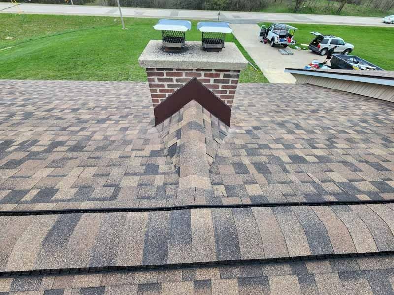 A roof with a brick chimney on top of it.