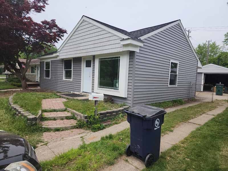 A house with a window and scaffolding on the side of it.