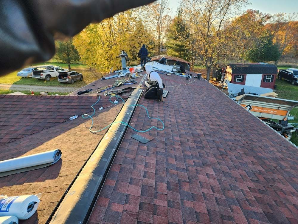 A man is working on the roof of a house.
