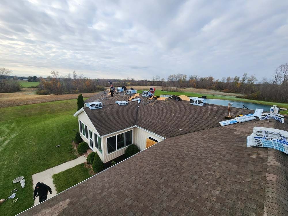 An aerial view of a house with a roof being installed.