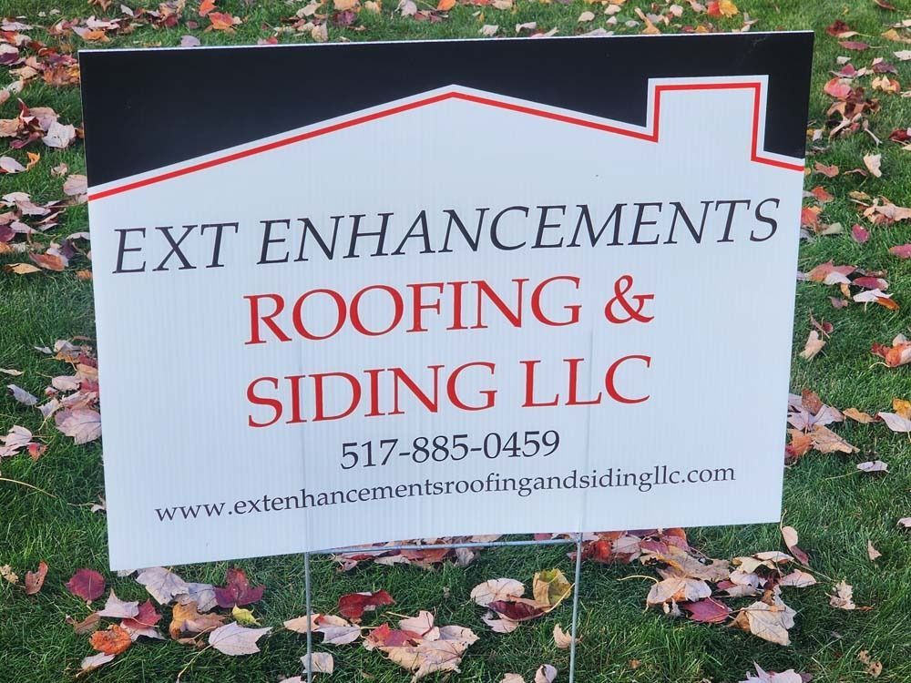 A yard sign for ext enhancements roofing and siding llc