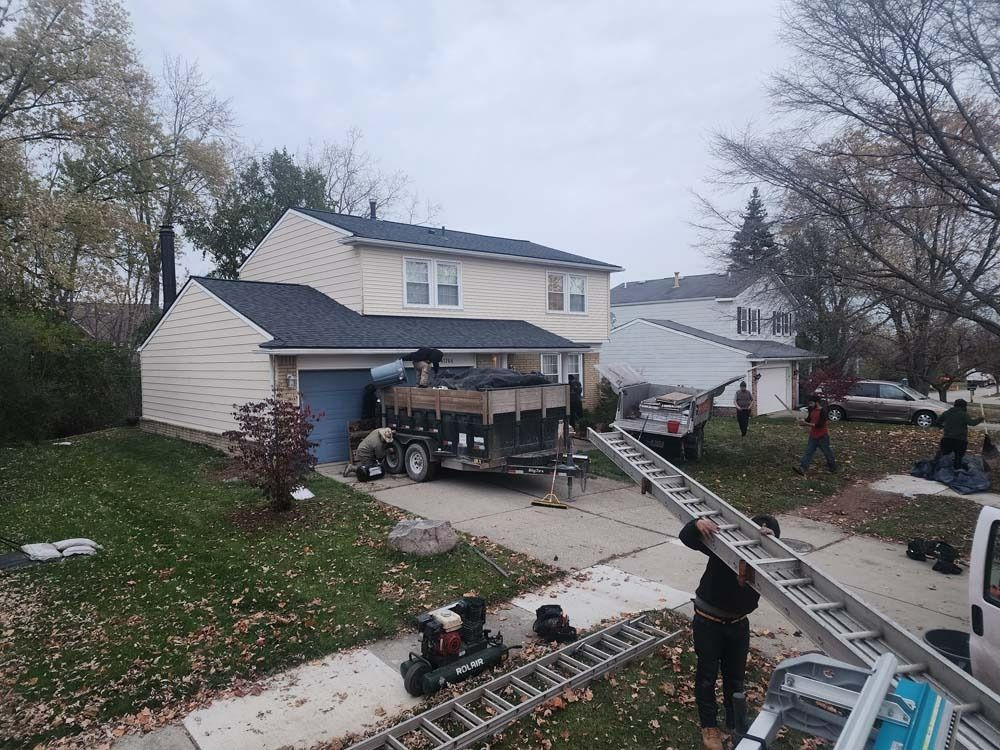 A man is holding a ladder in front of a house.