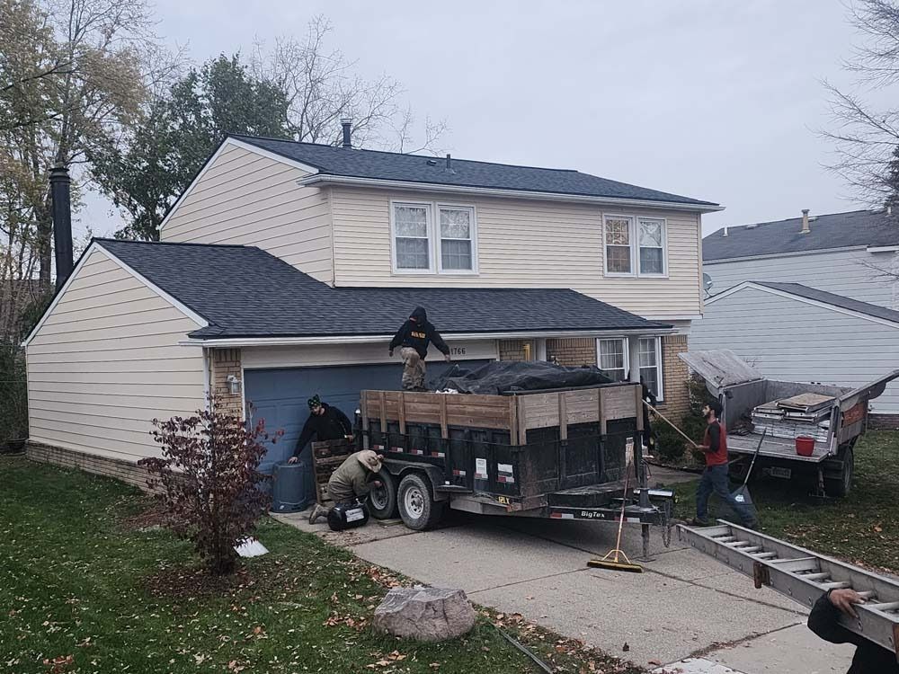 A house with a trailer parked in front of it.