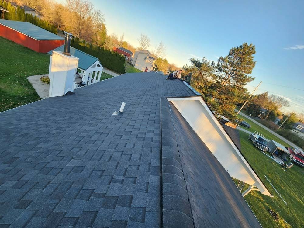 A roof with a gutter and a chimney on it.