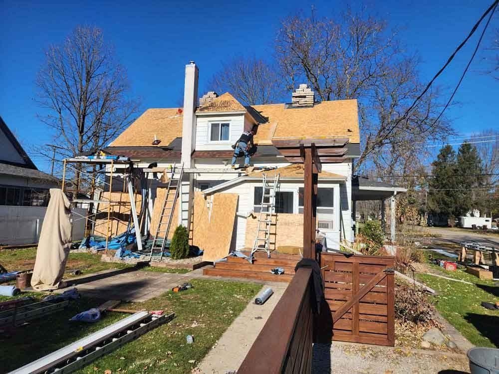 A house is being remodeled with a new roof.