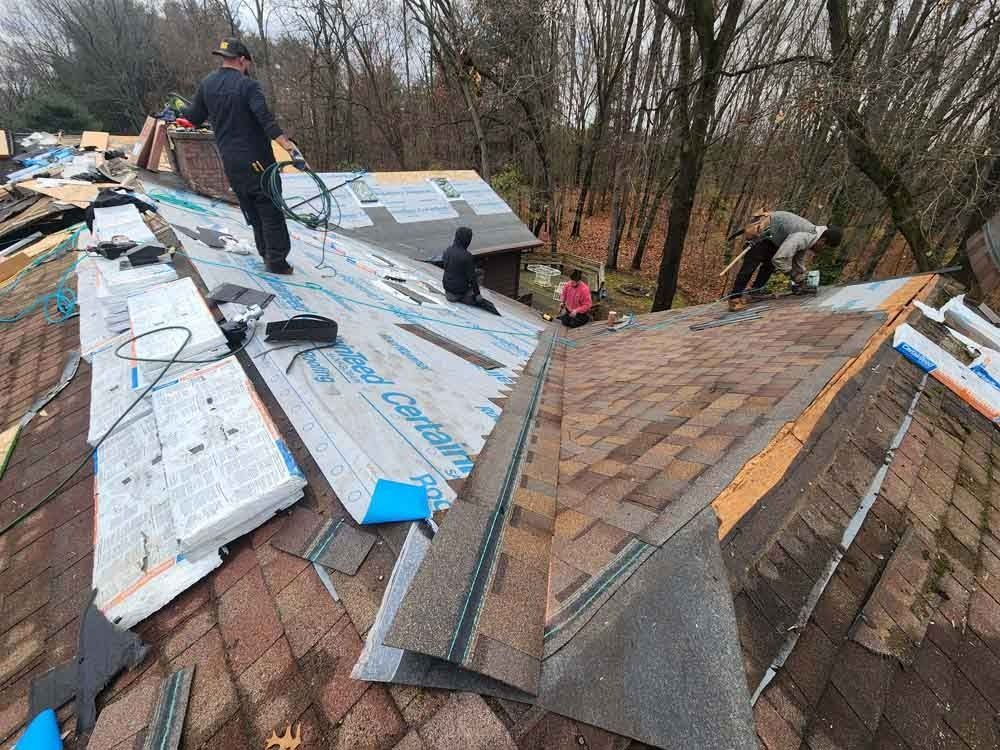 A group of people are working on a roof.