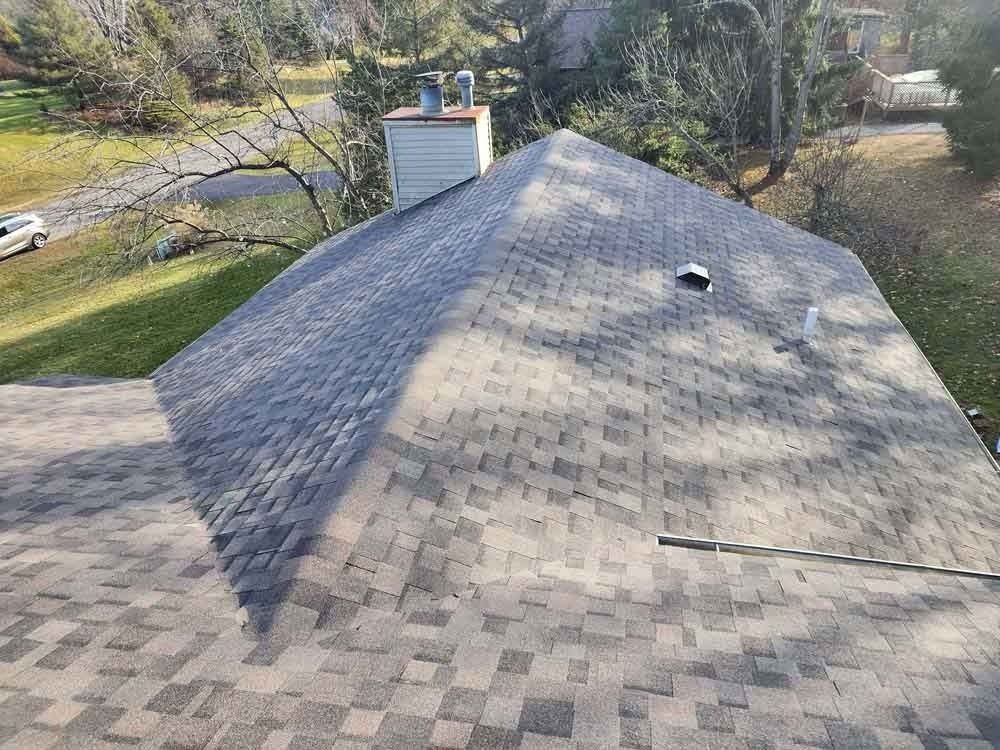 An aerial view of a roof with a chimney on it.